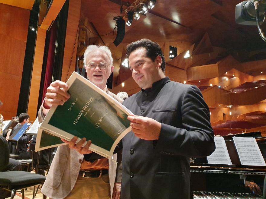 John Adams konpositorea eta Robert Treviño 'Harmoniehlere' obraren partitura aztertzen entsegu batean. Ekainaren 17an jo zuen Orkestrak BBVA Fundazioaren Jakintzaren Mugak Sarien baitan Euskalduna Jauregian eskainitako kontzertu batean.